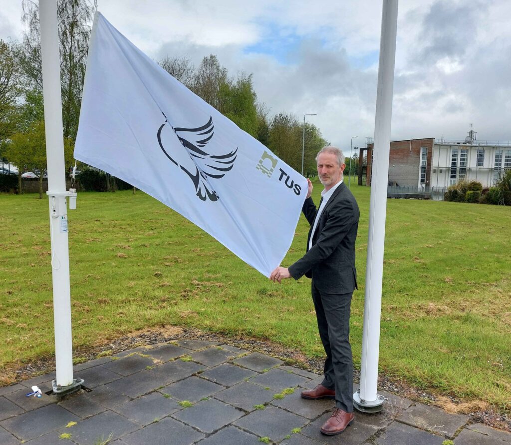 Pictured: Seamus Hoyne, Dean of Flexible and Work-Based Learning, TUS, raises the peace flag on TUS Thurles Campus.
