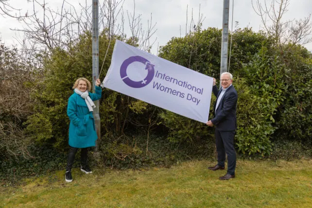 TUS IWD Caption-1-Jackie-Farrell-EDI-manager-at-TUS-Midlands-and-TUS-President-Professor-Vincent-Cunnane-raise-a-flag-in-celebration-of-International-Womens-Day-scaled