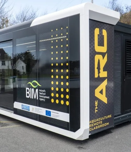 The ARC, a mobile aquaculture training classroom operated by BIM, Ireland’s Seafood Development Agency, featuring black and yellow branding on a converted transport trailer.