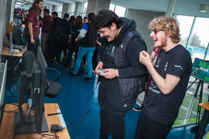 Two attendees of the 2026 Games Fleadh in Thurles playing a video game.